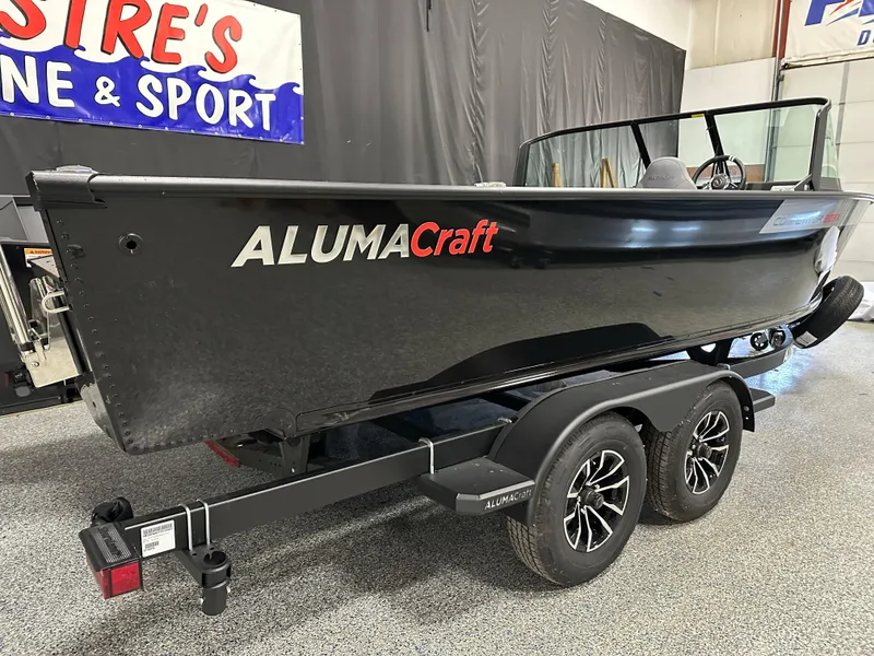 Slide: The Image of 2025 Alumacraft Competitor 205X Sport boat on trailer in showroom. - 1