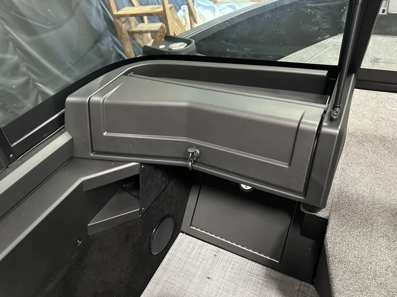Slide: The Image of Interior of 2025 Alumacraft Competitor 205X Sport boat, featuring a storage compartment. - 11