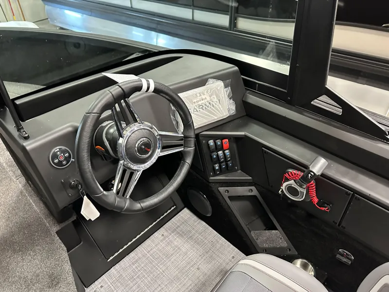 Slide: The Image of 2025 Alumacraft Competitor 205X Sport boat dashboard with steering wheel and control panel. - 12