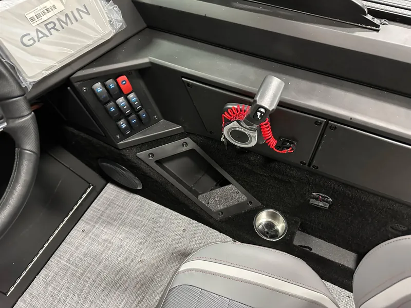 Slide: The Image of 2025 Alumacraft Competitor 205X Sport dashboard with Garmin device and control panel. - 15