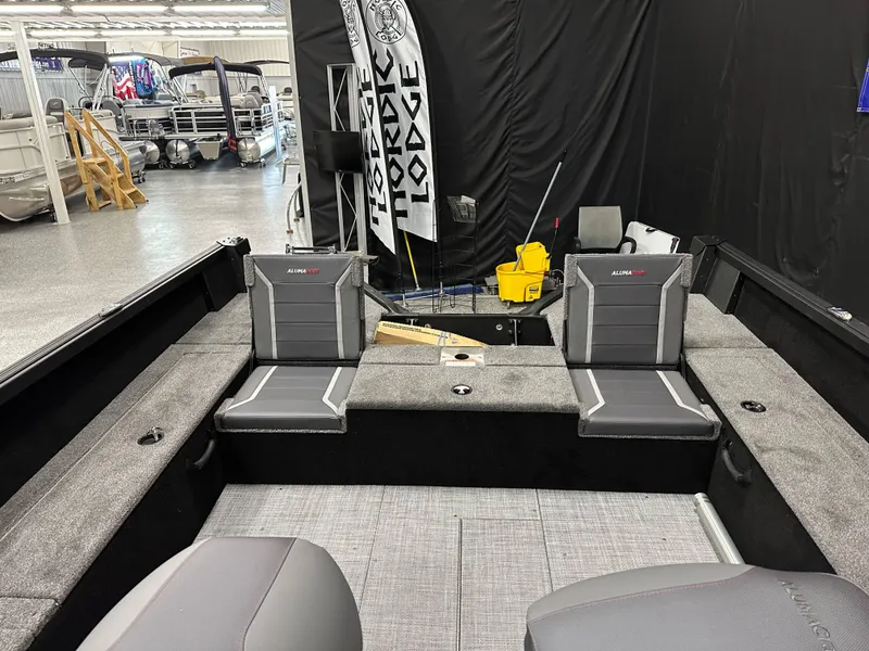 Slide: The Image of 2025 Alumacraft Competitor 205X Sport interior with gray seating and carpeted flooring. - 17