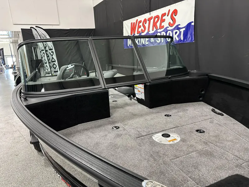 Slide: The Image of 2025 Alumacraft Competitor 205X Sport boat interior with spacious deck and windshield. - 2