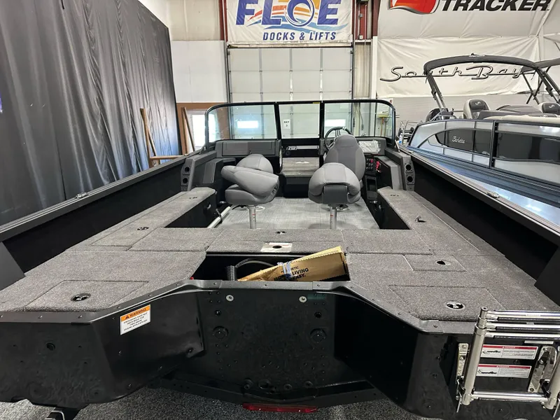 Slide: The Image of 2025 Alumacraft Competitor 205X Sport boat interior with seating and storage compartments. - 21