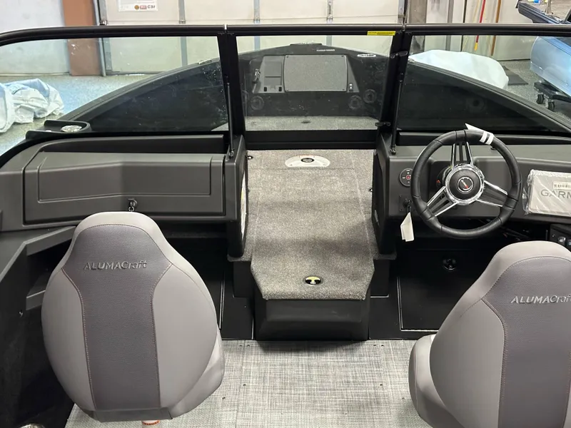Slide: The Image of 2025 Alumacraft Competitor 205X Sport boat interior with steering wheel and seats. - 8