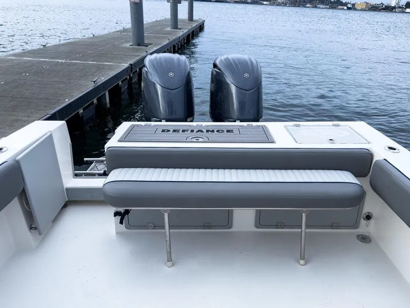 Slide: The Image of 2025 Defiance 260 Admiral boat with dual engines docked by the water. - 11
