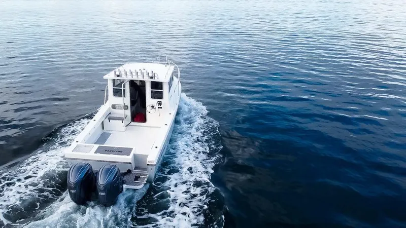 Slide: The Image of 2025 Defiance 260 Admiral boat cruising on open water. - 3