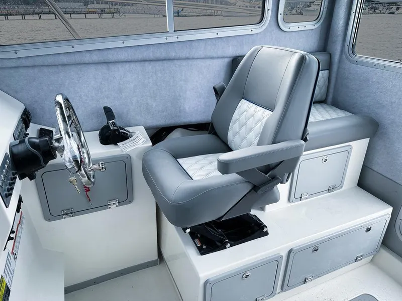 Slide: The Image of Interior of 2025 Defiance 260 Admiral boat with captain's chair and steering wheel. - 4