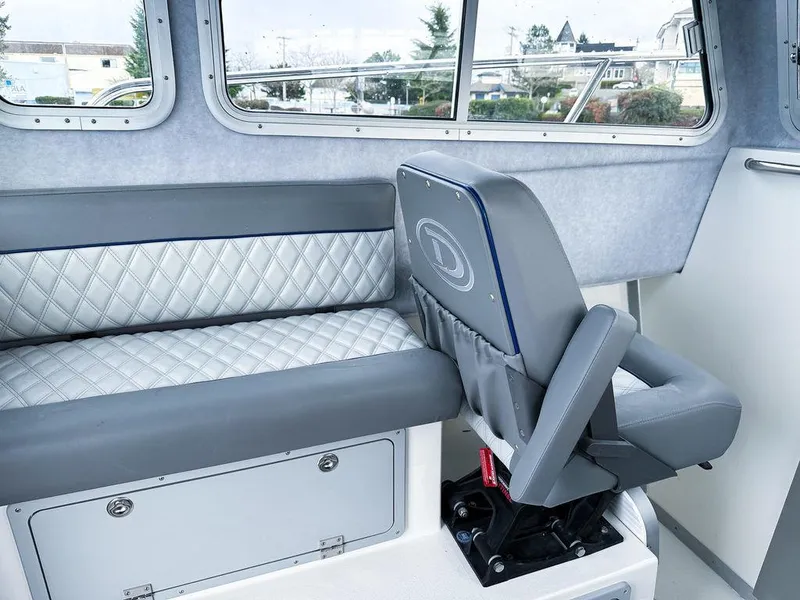 Slide: The Image of Interior of 2025 Defiance 260 Admiral boat with quilted seating and windows. - 5