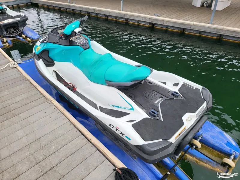 Slide: The Image of 2022 Sea-Doo GTX PRO 130 jet ski docked on water. - 5
