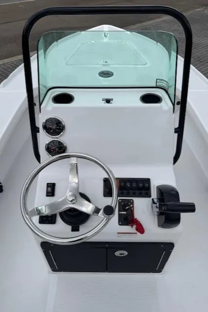 Slide: The Image of 2025 Action Craft 17 Flats boat console with steering wheel and controls. - 14