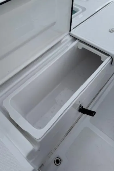 Slide: The Image of 2025 Action Craft 17 Flats boat storage compartment, open and empty. - 23