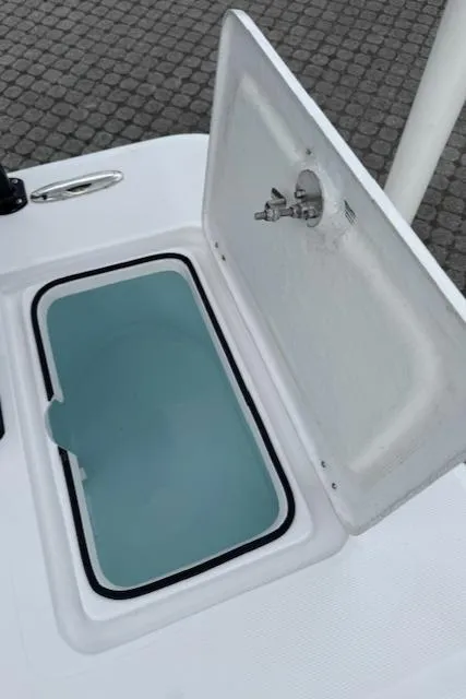Slide: The Image of 2025 Action Craft 17 Flats boat livewell with open lid, showcasing interior. - 24