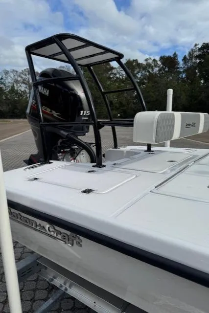 Slide: The Image of 2025 Action Craft 17 Flats boat with Yamaha 115 engine, parked outdoors. - 25