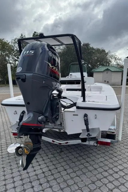 Slide: The Image of 2025 Action Craft 17 Flats boat with Yamaha 115 engine, parked on paved surface. - 27