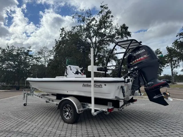 Slide: The Image of 2025 Action Craft 17 Flats boat on trailer with Yamaha outboard motor, parked outdoors. - 5