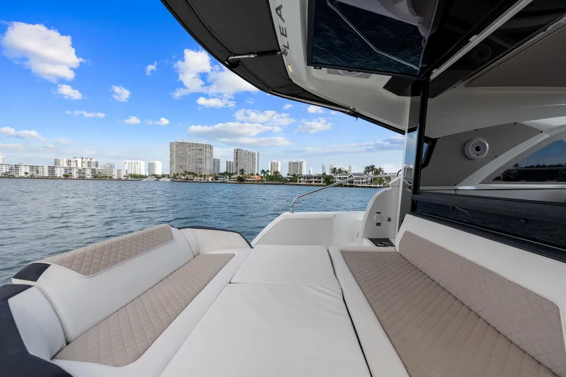 Slide: The Image of 2018 Jeanneau Leader 46 yacht with spacious deck, city skyline in background. - 13