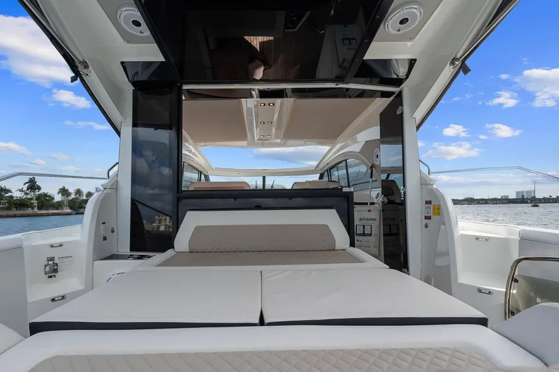Slide: The Image of 2018 Jeanneau Leader 46 yacht interior with luxurious seating and open water view. - 15
