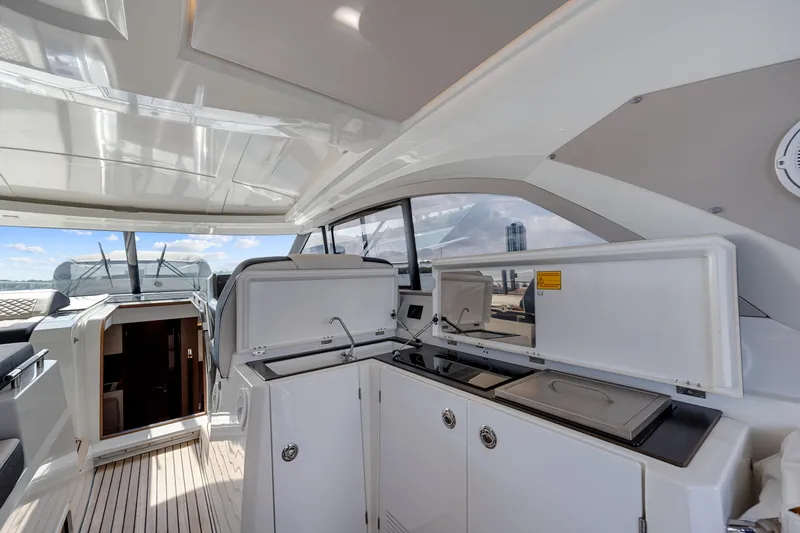 Slide: The Image of 2018 Jeanneau Leader 46 yacht interior with modern kitchen and open deck view. - 28
