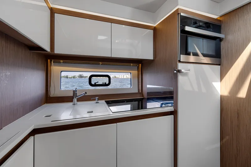 Slide: The Image of Modern kitchen interior of 2018 Jeanneau Leader 46 yacht with sleek cabinetry and appliances. - 31