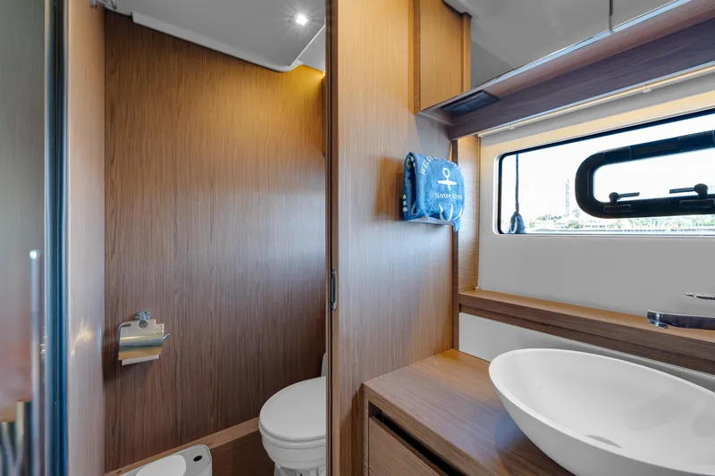 Slide: The Image of Luxurious bathroom in 2018 Jeanneau Leader 46 yacht with modern fixtures and wood accents. - 39