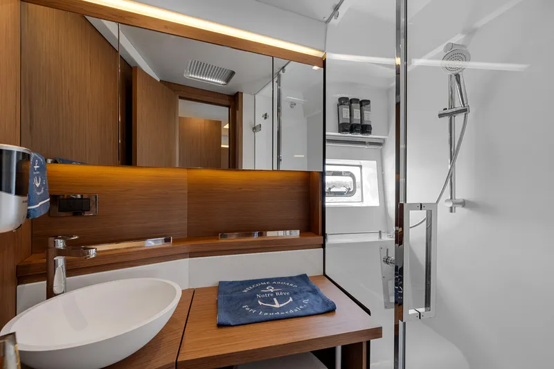 Slide: The Image of Luxurious bathroom interior of 2018 Jeanneau Leader 46 yacht with modern fixtures and wood accents. - 42