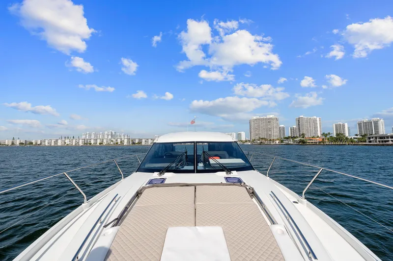 Slide: The Image of 2018 Jeanneau Leader 46 yacht cruising on open water under a clear blue sky. - 48