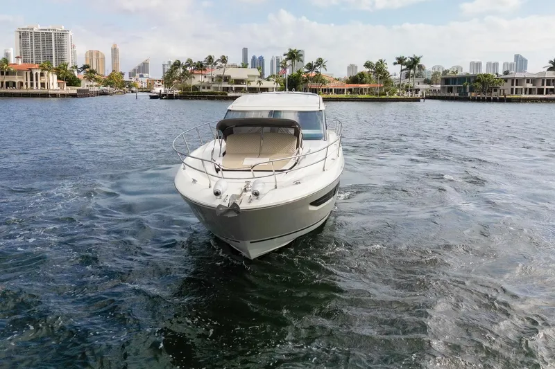 Slide: The Image of 2018 Jeanneau Leader 46 yacht cruising in a scenic waterfront setting. - 5