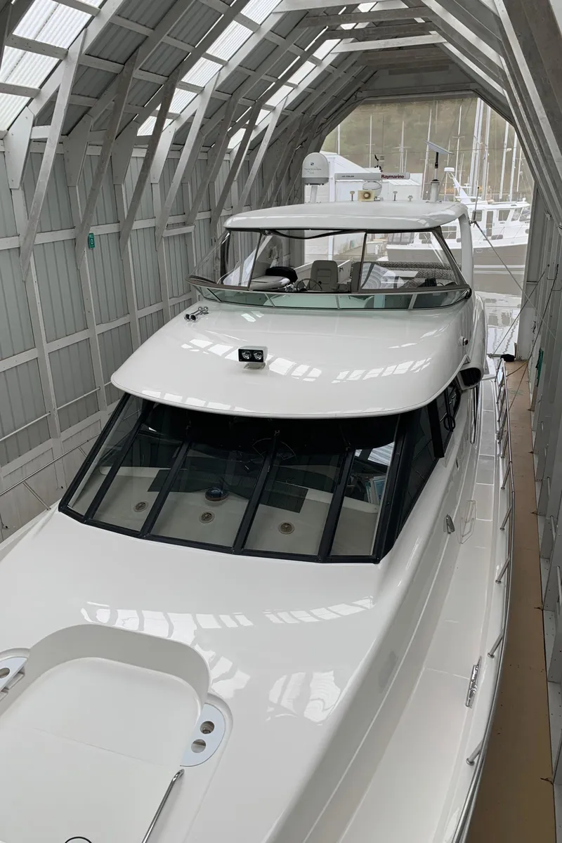 Slide: The Image of 1997 Bayliner Pilothouse with inflatable boat and patterned seating on deck. - 15