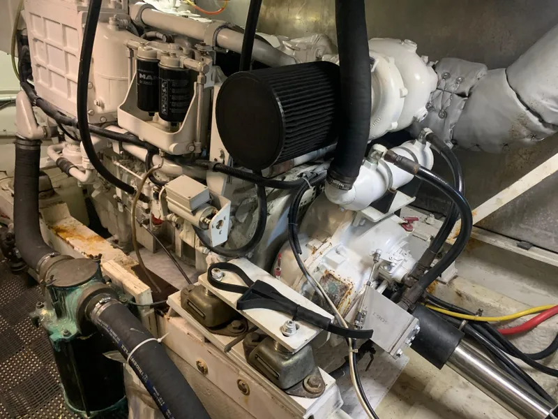 Slide: The Image of 1997 Bayliner Pilothouse yacht with outdoor seating and ladder in covered dock. - 22