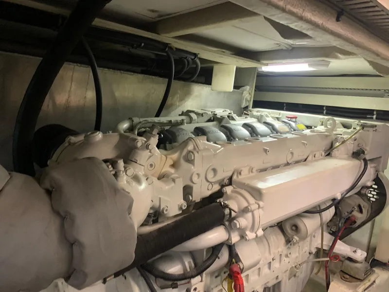 Slide: The Image of Engine room of 1997 Bayliner 5788 Pilot House Motoryacht with visible machinery and fire extinguisher. - 24