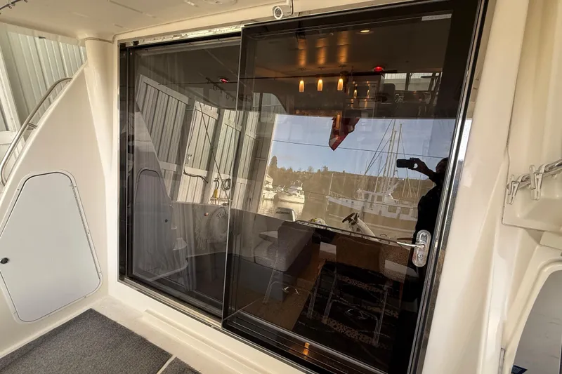 Slide: The Image of Side view of 1997 Bayliner 5788 Pilot House Motoryacht in a marina. - 34