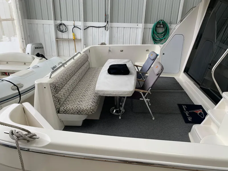 Slide: The Image of Luxurious interior of 1997 Bayliner 5788 Pilot House Motoryacht with elegant dining area. - 4