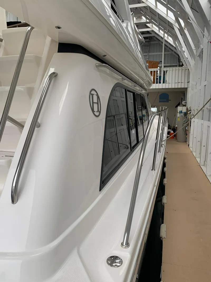 Slide: The Image of 1997 Bayliner Pilothouse helm with steering wheel, navigation screens, and control panels. - 5