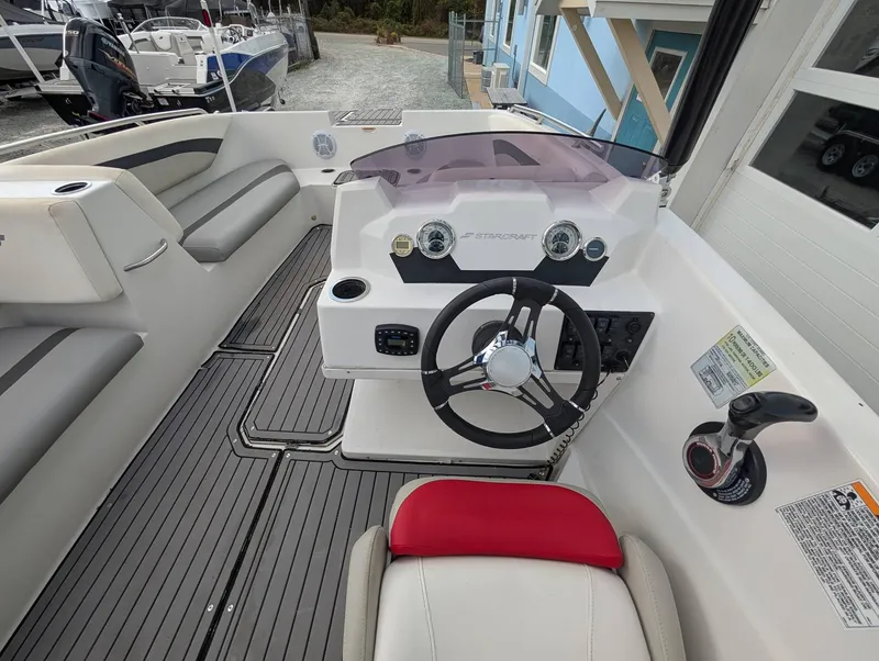 Slide: The Image of 2020 Starcraft SVX 171 boat interior with steering wheel and seating. - 13
