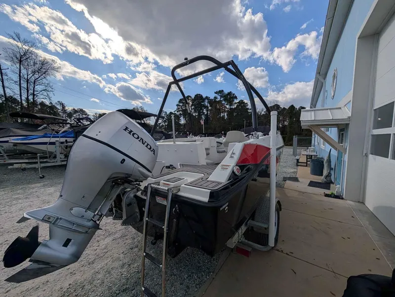 Slide: The Image of 2020 Starcraft SVX 171 boat with Honda outboard motor, parked outdoors. - 4