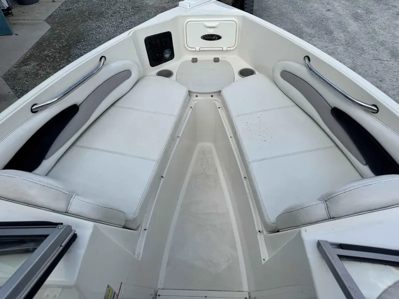 Slide: The Image of 2009 Stingray 195 FX Fish & Ski boat interior with white seating and stainless steel handles. - 6