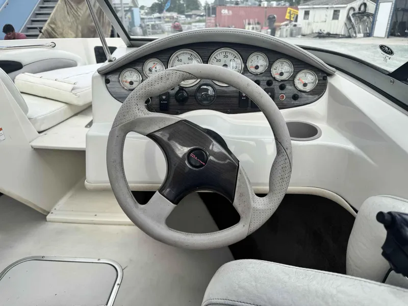 Slide: The Image of 2009 Stingray 195 FX Fish & Ski boat dashboard with steering wheel and gauges. - 9