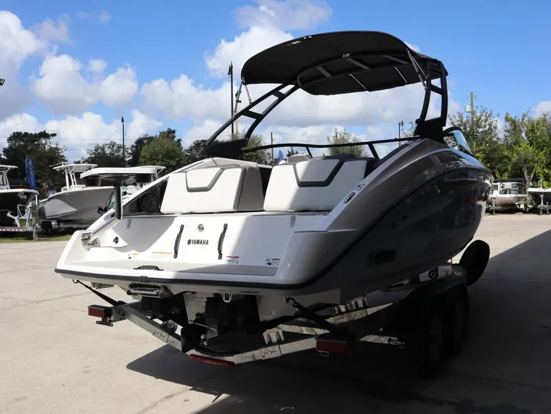 Slide: The Image of 2025 Yamaha AR250 boat on trailer under clear blue sky. - 4