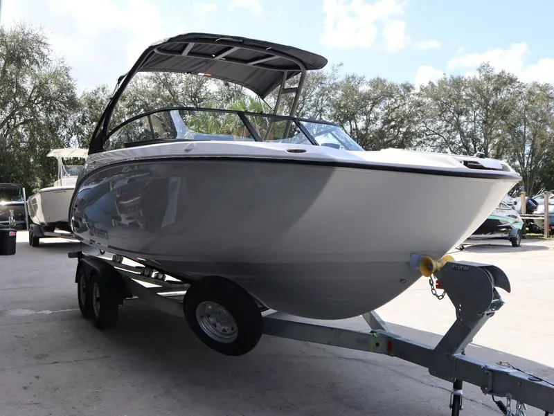 Slide: The Image of 2025 Yamaha Boats AR250 on trailer, parked outdoors under clear sky. - 6