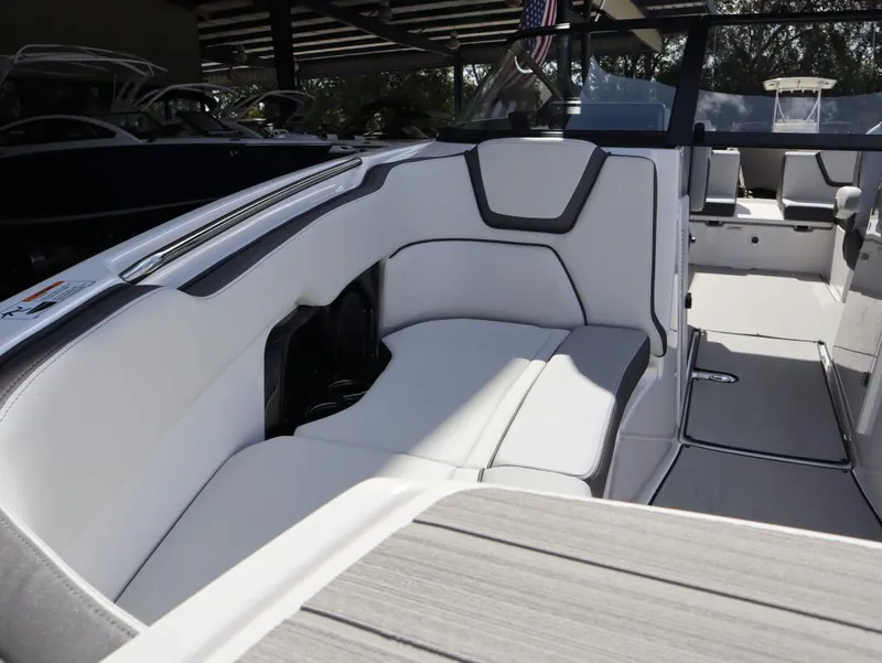 Slide: The Image of 2025 Yamaha Boats AR250 interior with sleek white seating and modern design. - 9