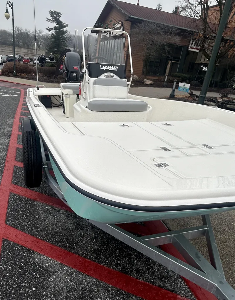 Slide: The Image of 2025 Mako Pro Skiff 15 CC boat on trailer, parked outdoors. - 1