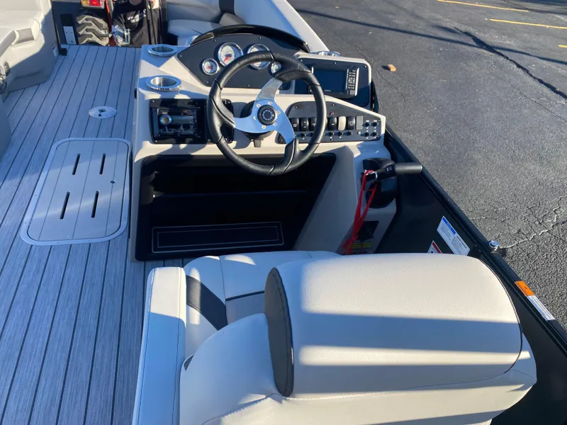 Slide: The Image of 2025 SunCatcher Select 322RC boat interior with steering wheel and seating. - 15
