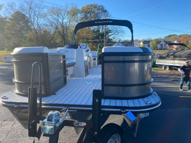 Slide: The Image of 2025 SunCatcher Select 322RC pontoon boat on trailer, parked outdoors. - 3