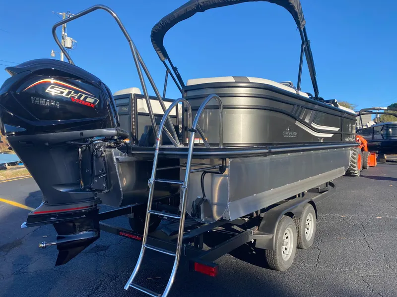 Slide: The Image of 2025 SunCatcher Select 322RC pontoon boat with Yamaha engine on trailer. - 5