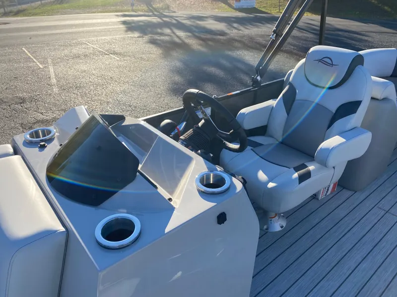 Slide: The Image of SunCatcher Select 322RC 2025 boat interior with steering wheel and comfortable seating. - 8