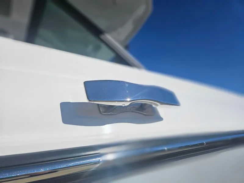 Slide: The Image of Close-up of 2025 Monterey Elite 30 OB boat handle against clear blue sky. - 10