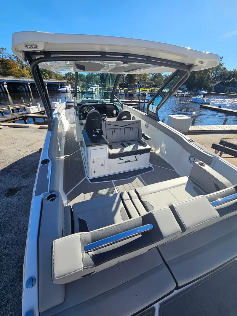 Slide: The Image of 2025 Monterey Elite 30 OB boat docked, featuring spacious seating and modern design. - 14