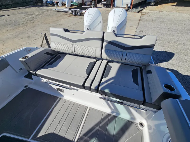 Slide: The Image of 2025 Monterey Elite 30 OB boat interior with stylish seating and dual outboard engines. - 18