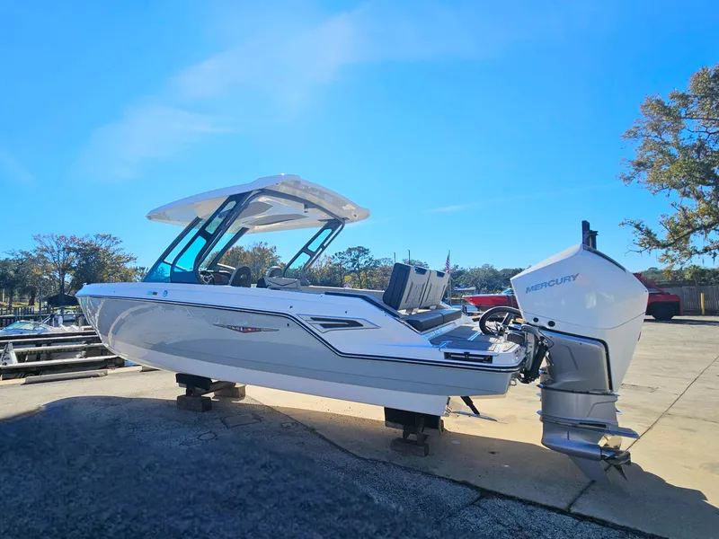 Slide: The Image of 2025 Monterey Elite 30 OB boat with Mercury outboard engine on display. - 2