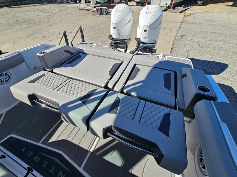 Slide: The Image of 2025 Monterey Elite 30 OB boat with dual outboard engines and luxurious seating. - 21